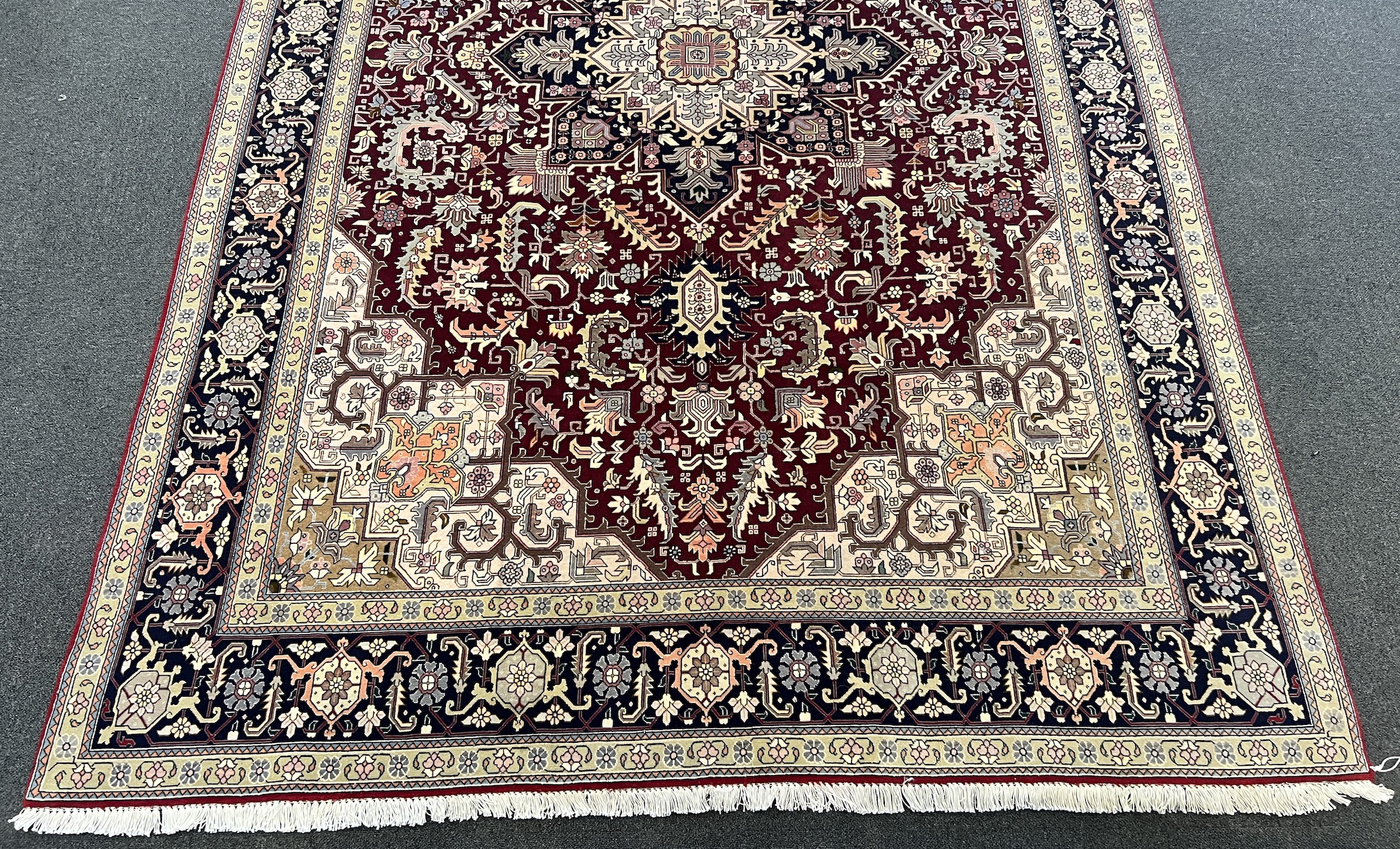 A Tabriz part silk burgundy ground carpet